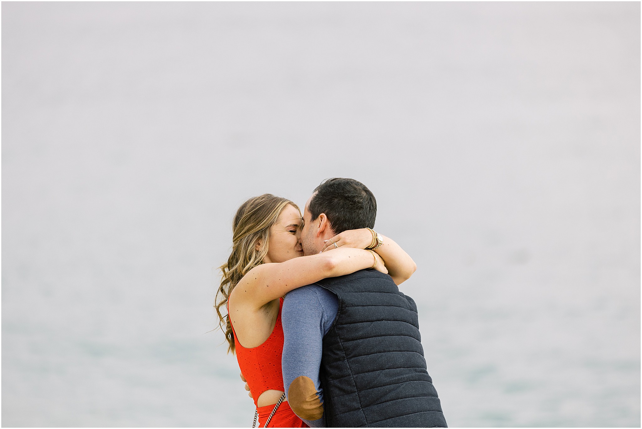 Backlit silhouette of the couple at sunset during their Carmel River Beach proposal