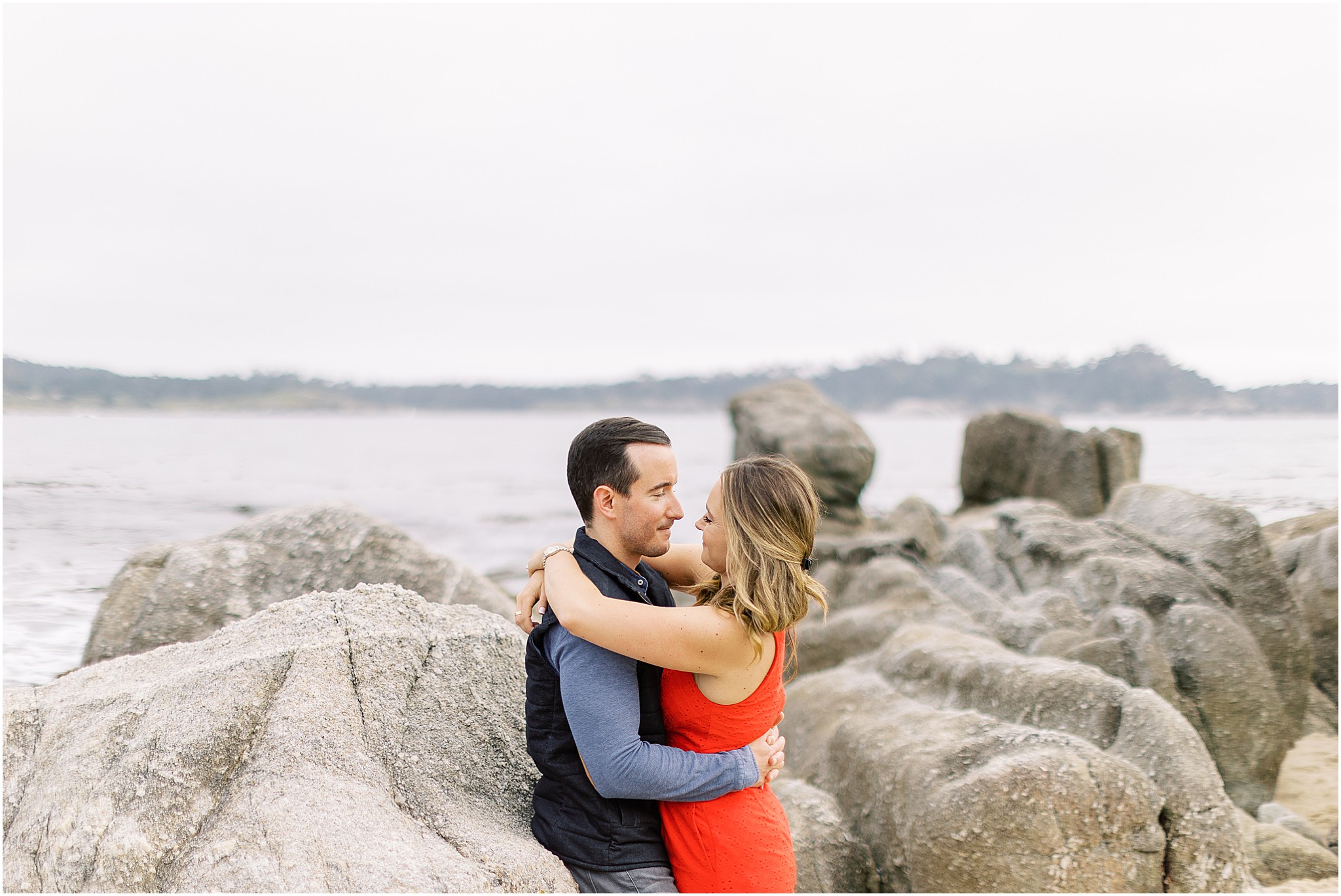 Nasim laughing while Chaplin looks at her during their beach proposal session.