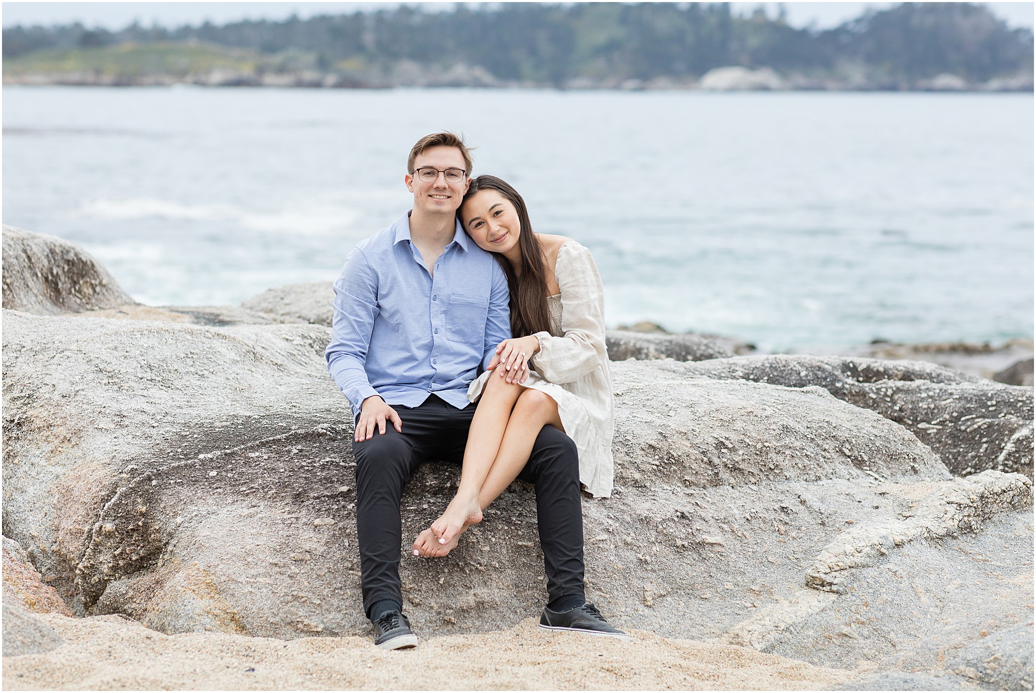 Close up portrait of Zach and Shannon smiling softly during their Carmel State Beach proposal.