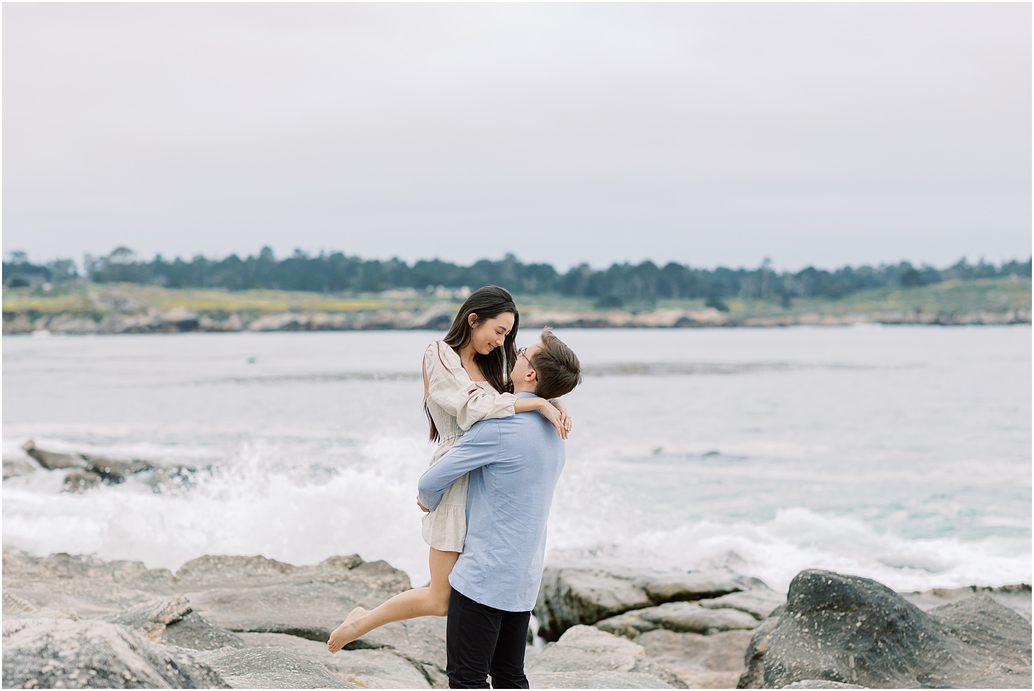 Groom to be looking lovingly at his bride to be on the California coast.