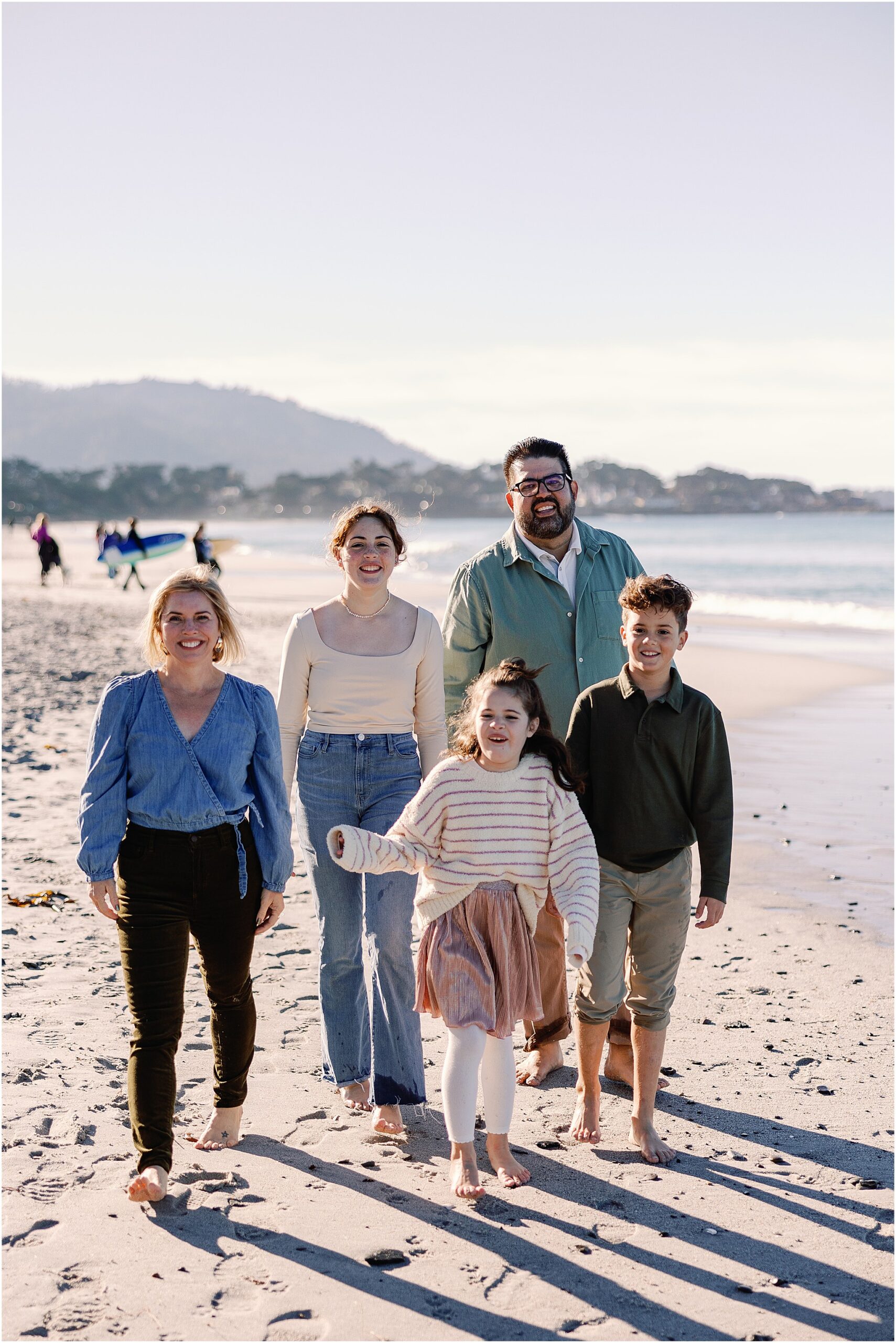 Family walking across the sand during Carmel beach family session