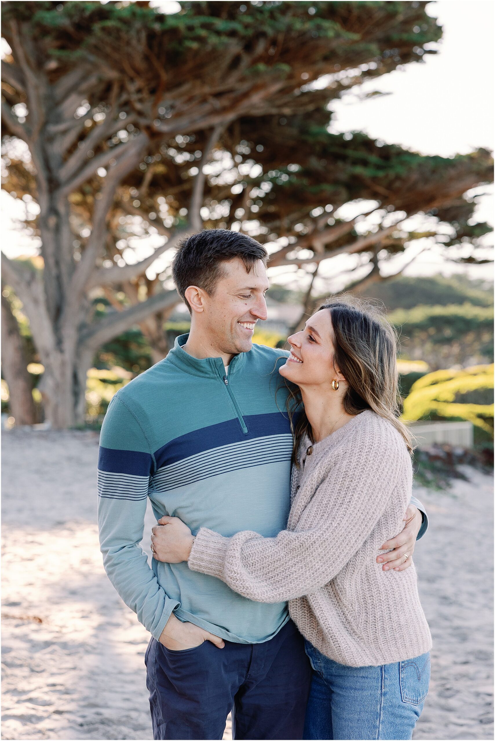 Parents embrace during Carmel beach family session