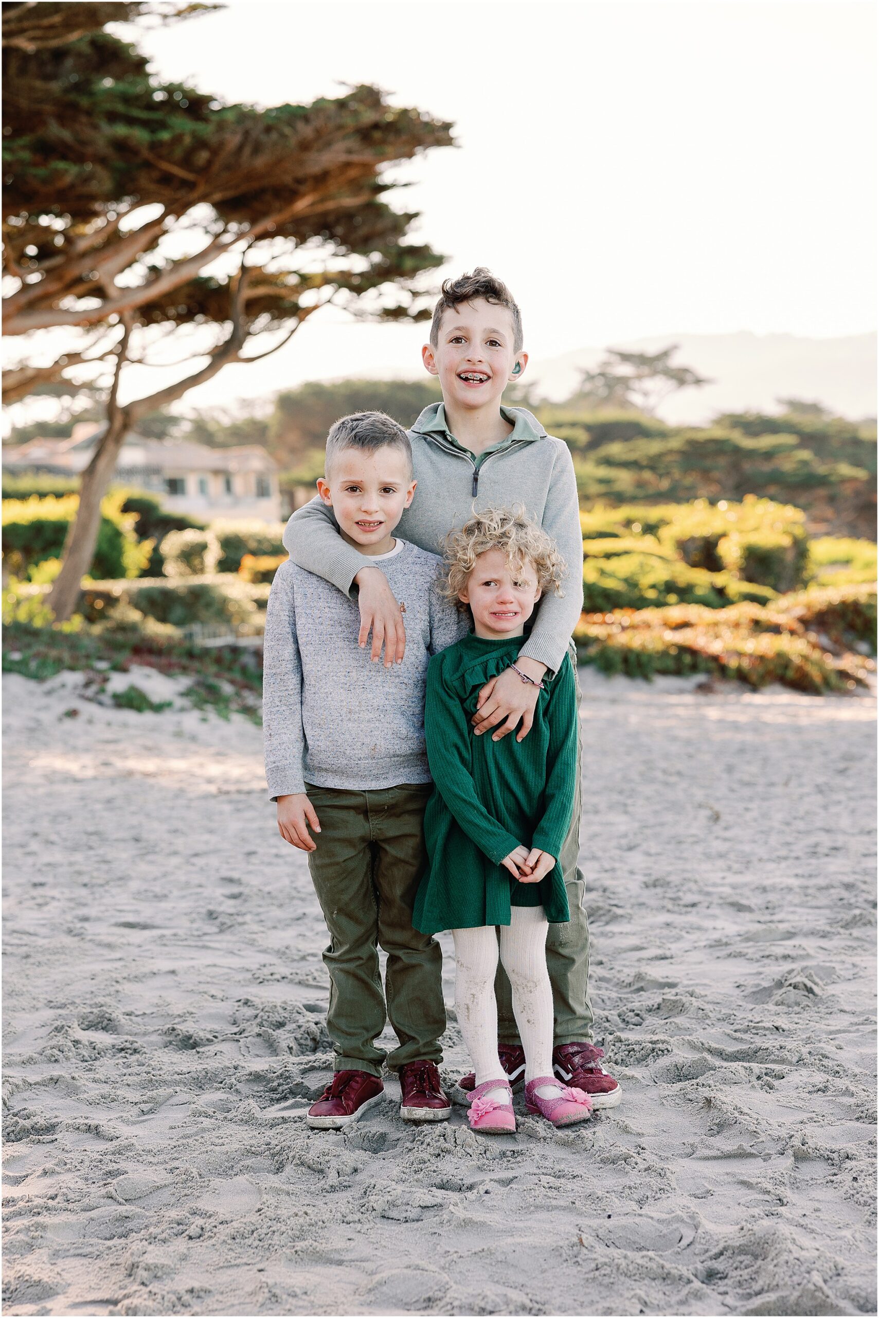 Kids laughing together during candid Carmel beach lifestyle session