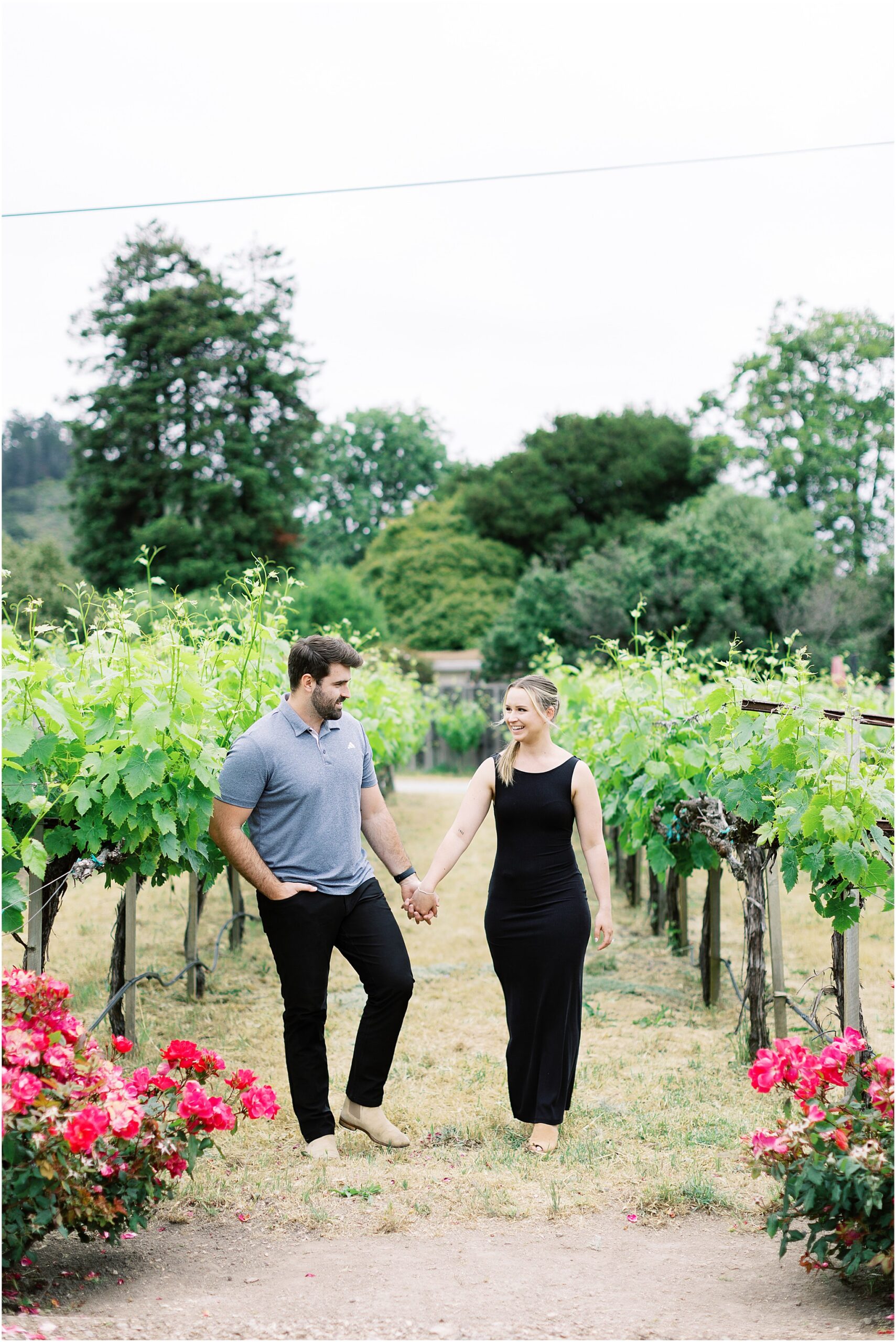 Couple laughing together in the vines during their Folktale Winery surprise proposal session.