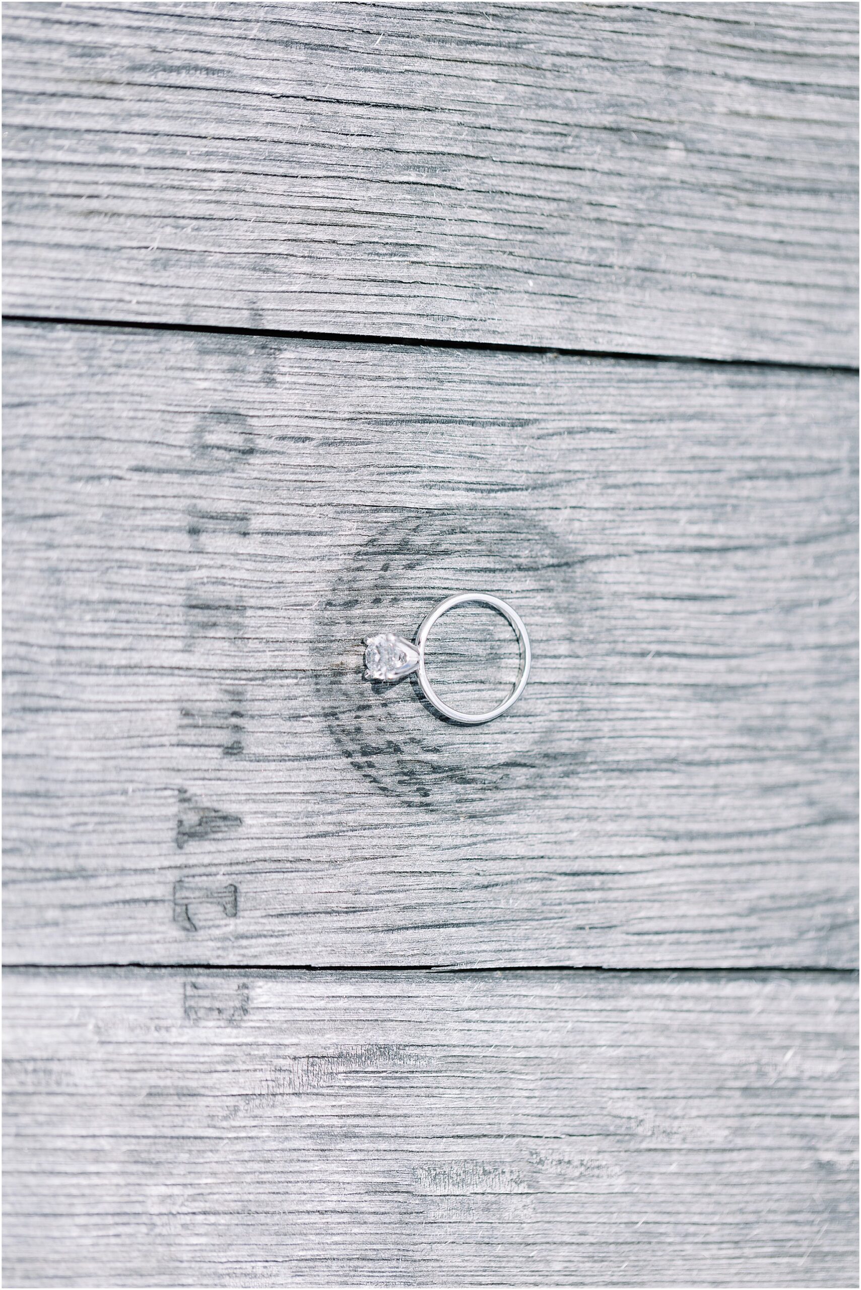 Closeup of oval solitaire ring sparkling after a Folktale Winery surprise proposal.