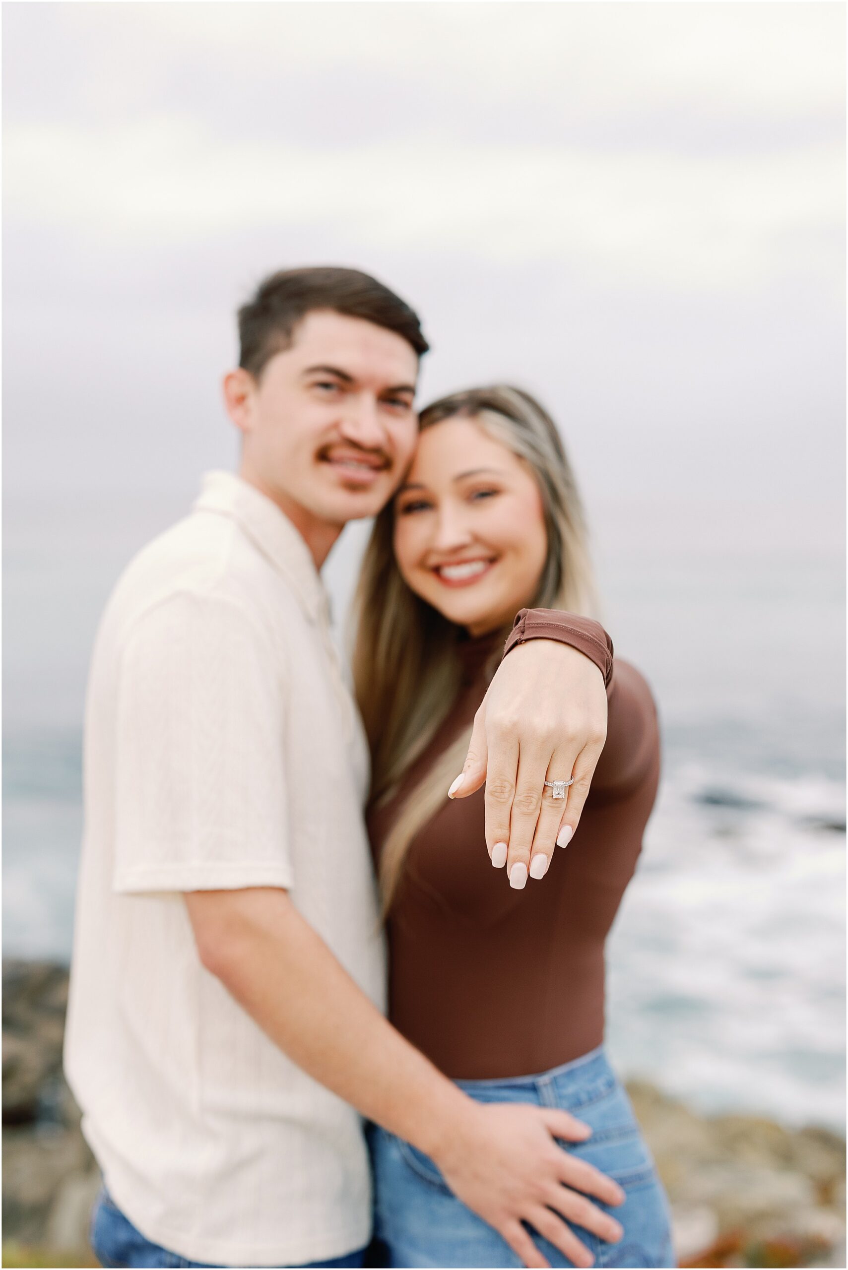 Close-up of Hayley’s emerald-cut engagement ring during their Carmel surprise proposal.