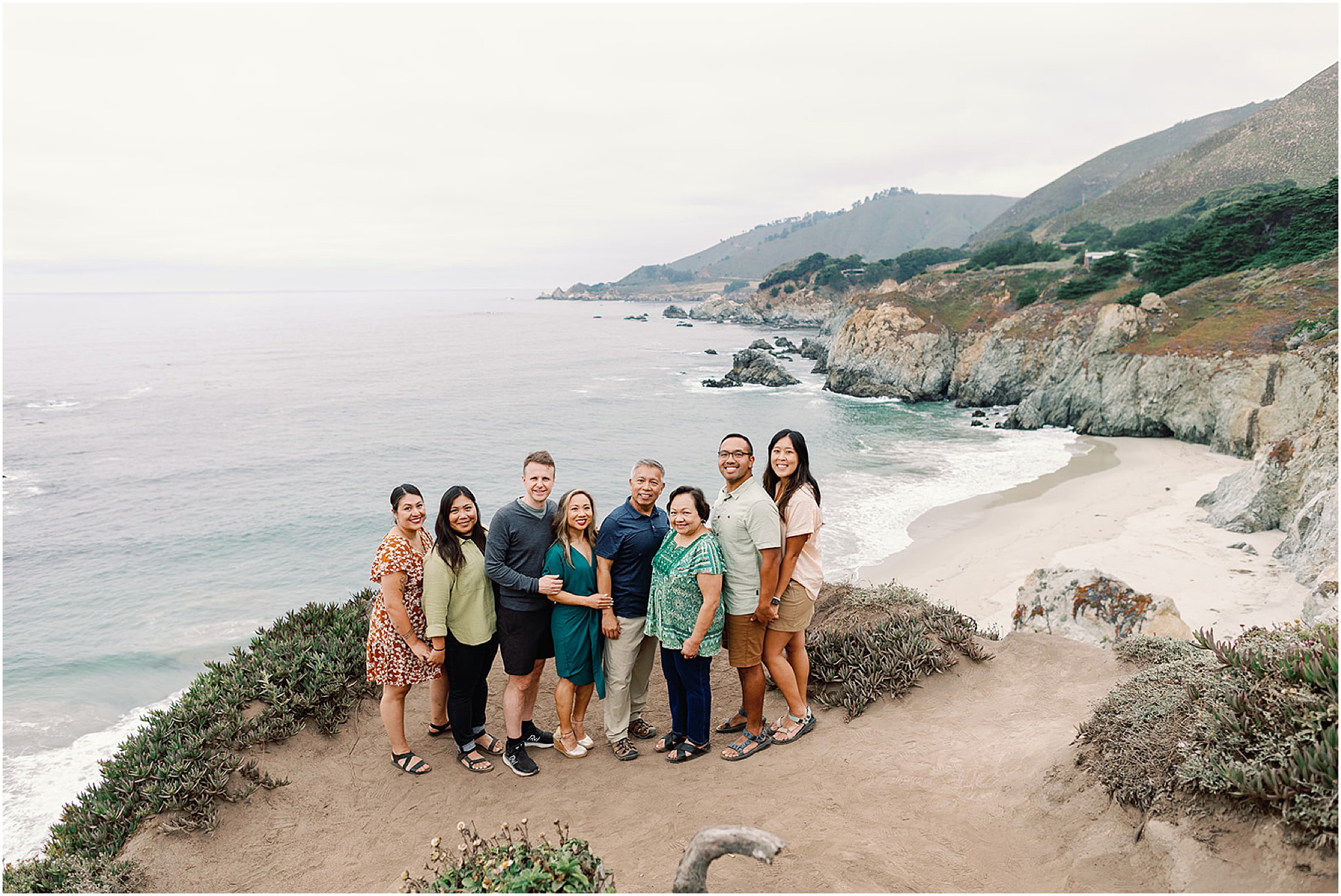 Sunset portrait of the Rozul Family standing on coastal cliffs overlooking the Pacific Ocean.