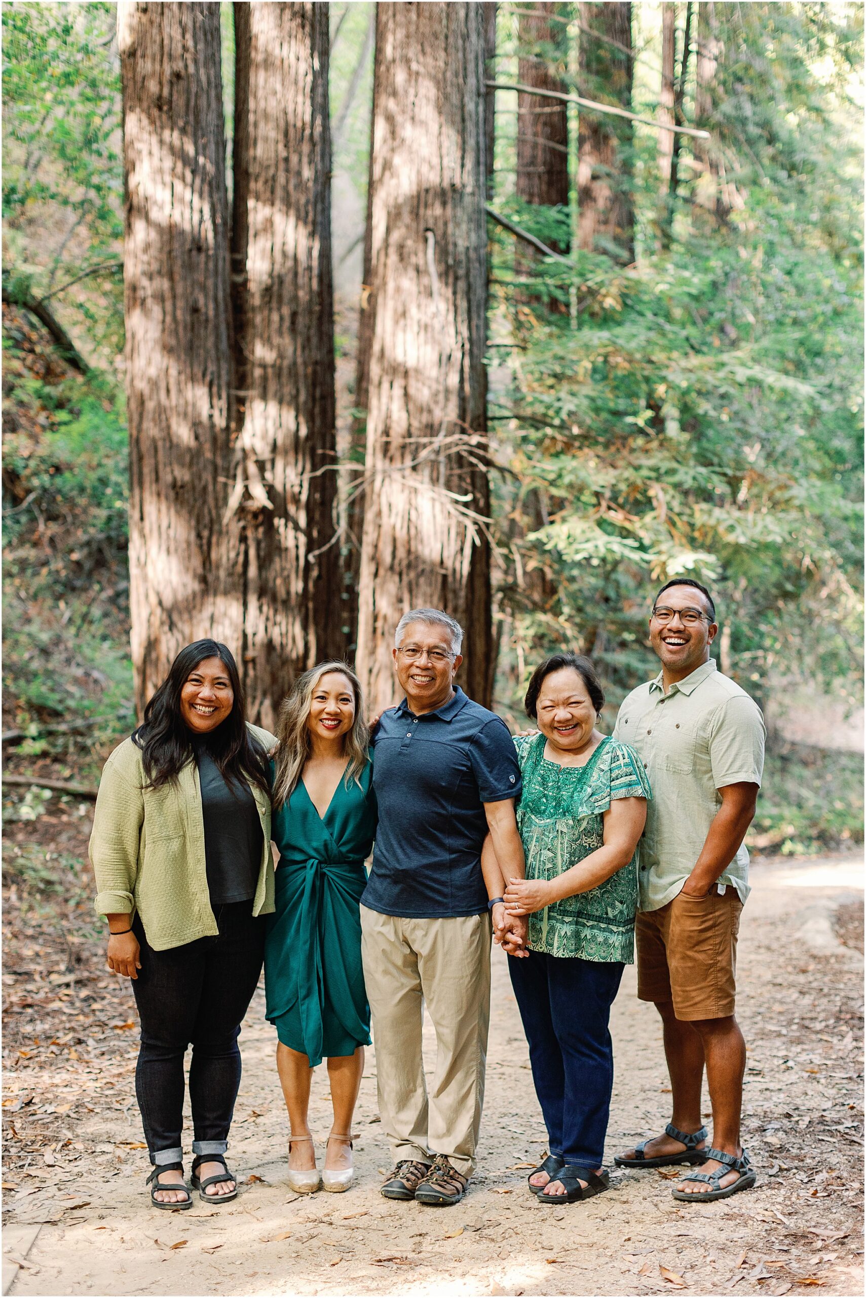 Family standing together in a redwood forest during their Big Sur family photography session.