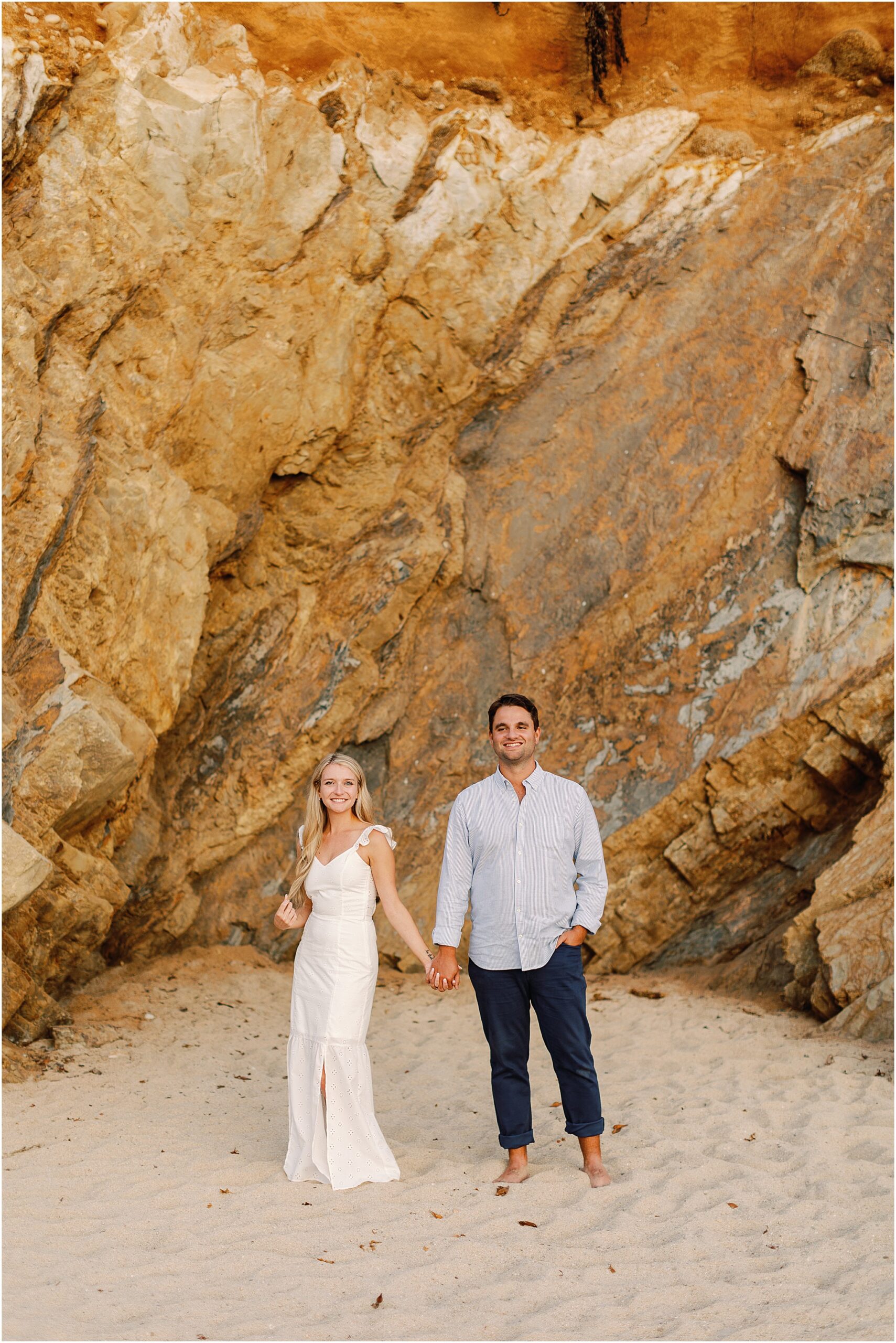 Joyful engagement portraits on a beach near the sea