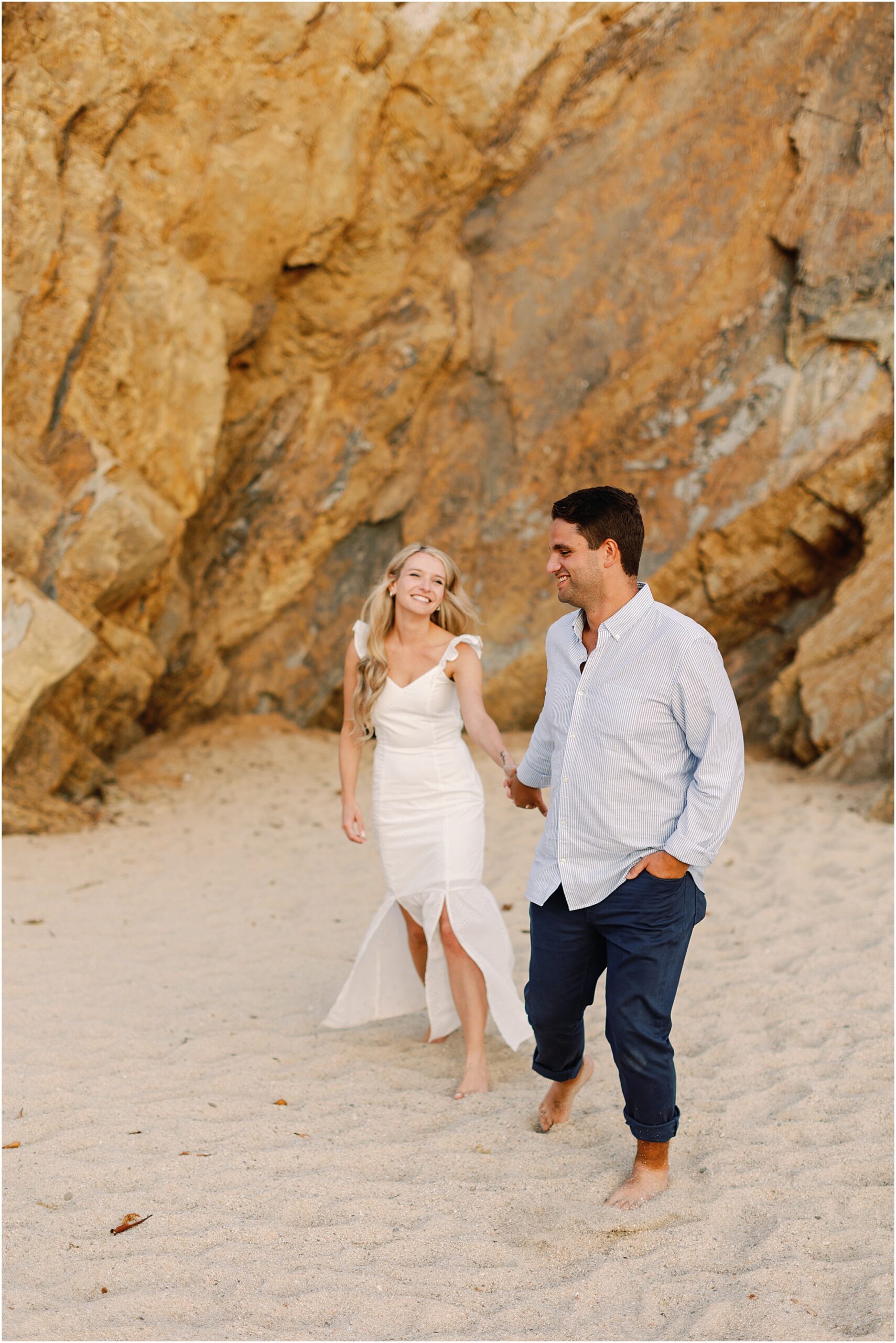 Couple having fun and enjoying the sunset after a surprise proposal on the coast