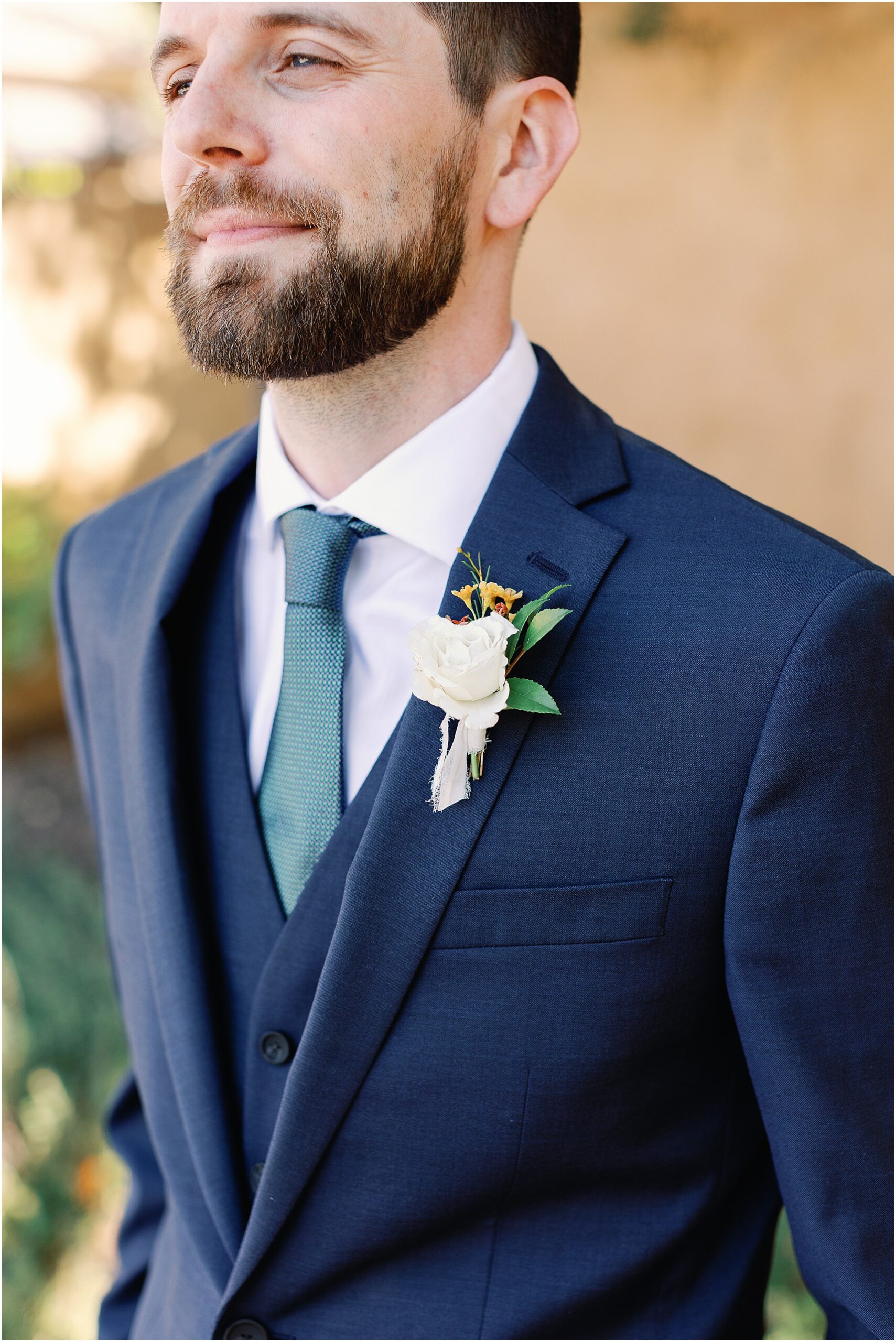 Elegant groom portrait photographed in natural light.