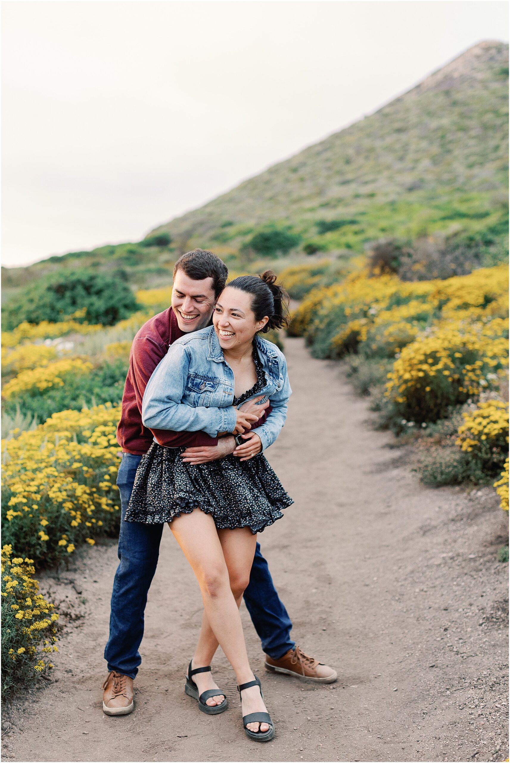 Ron and Anna sharing a joyful moment after getting engaged in Big Sur