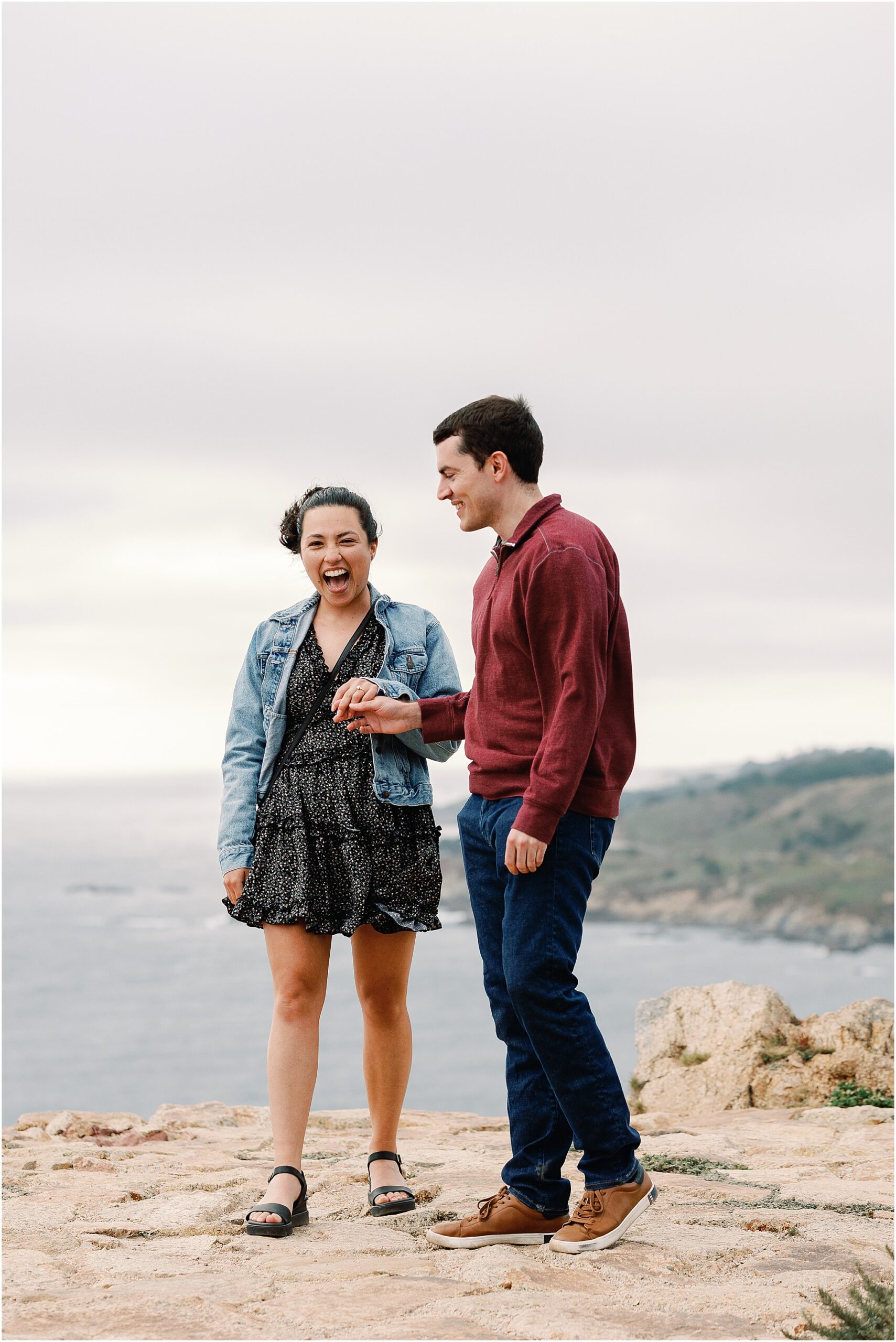 Anna reacting with joy as Ron proposes during their Big Sur sunset proposal.