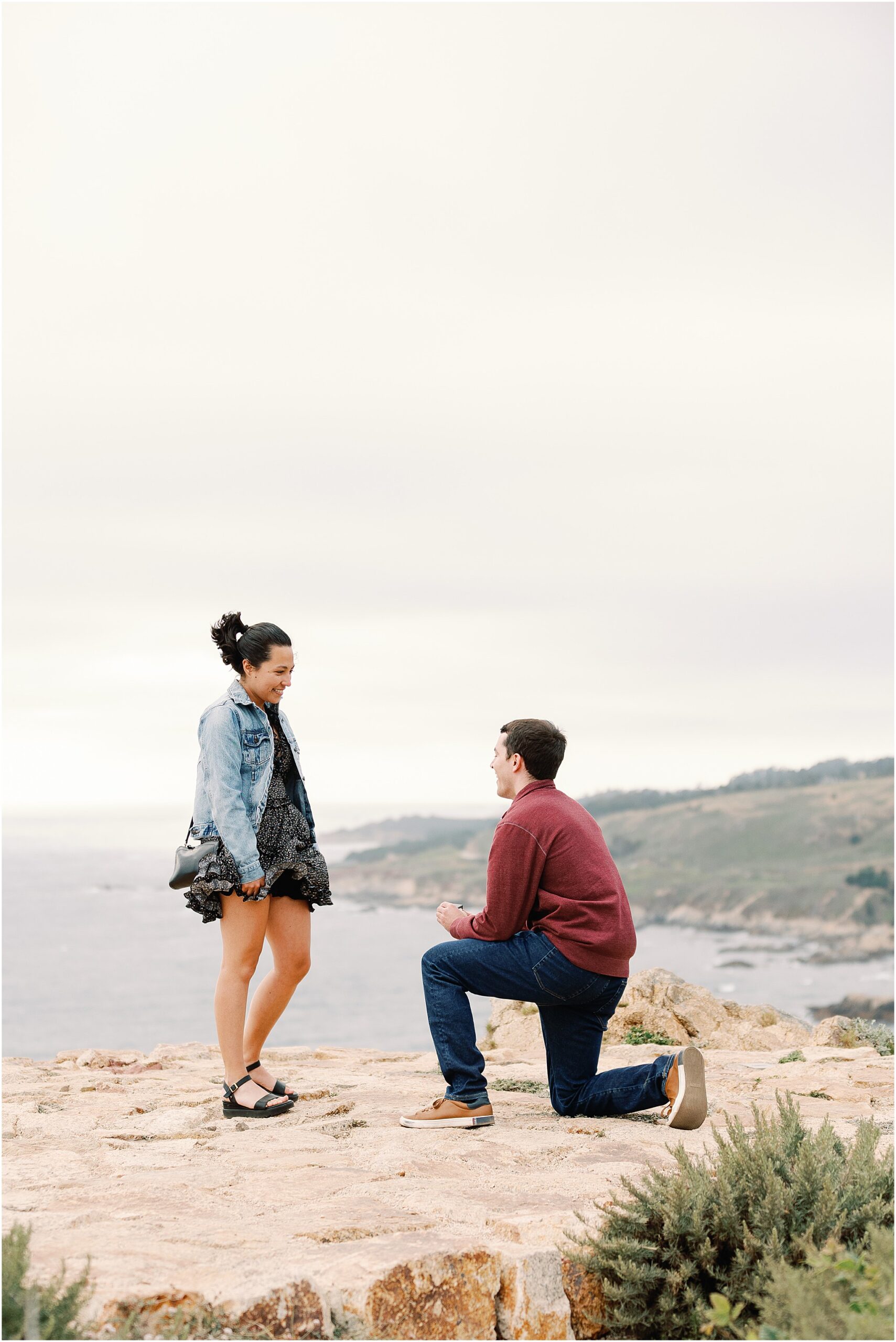Proposal in action at a Big Sur coastal overlook with Ron asking Anna to marry him.