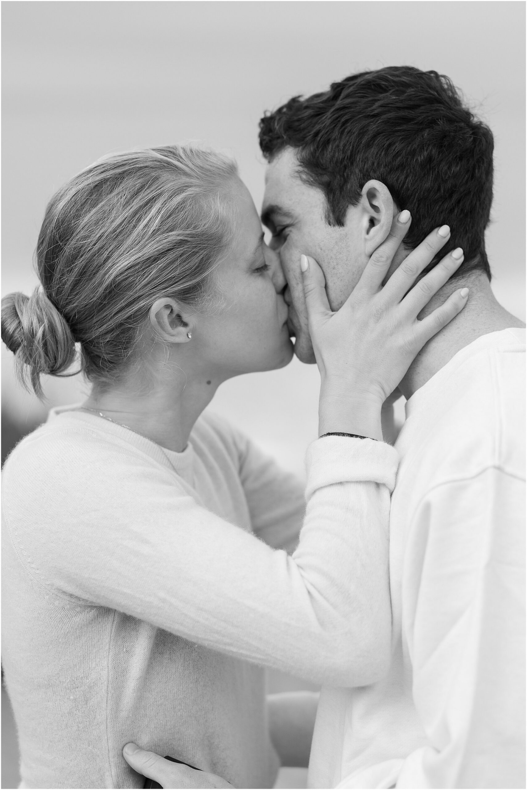 Romantic kiss on Carmel beach after engagement