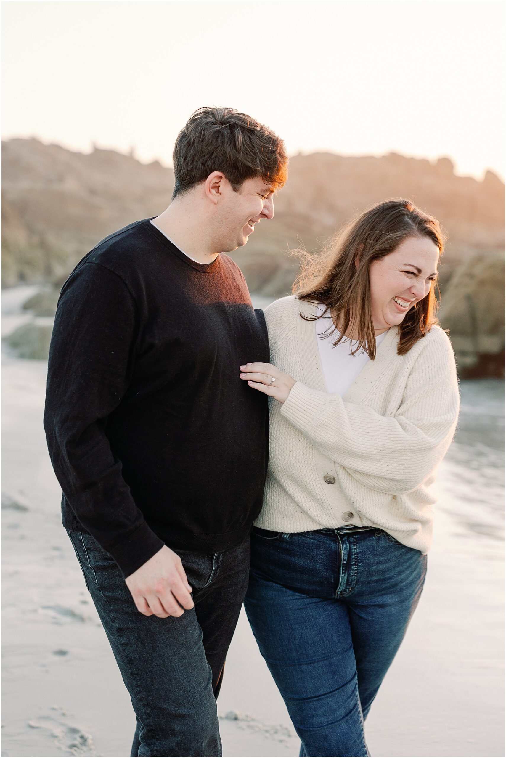 Candid moment of a couple laughing along the California coast