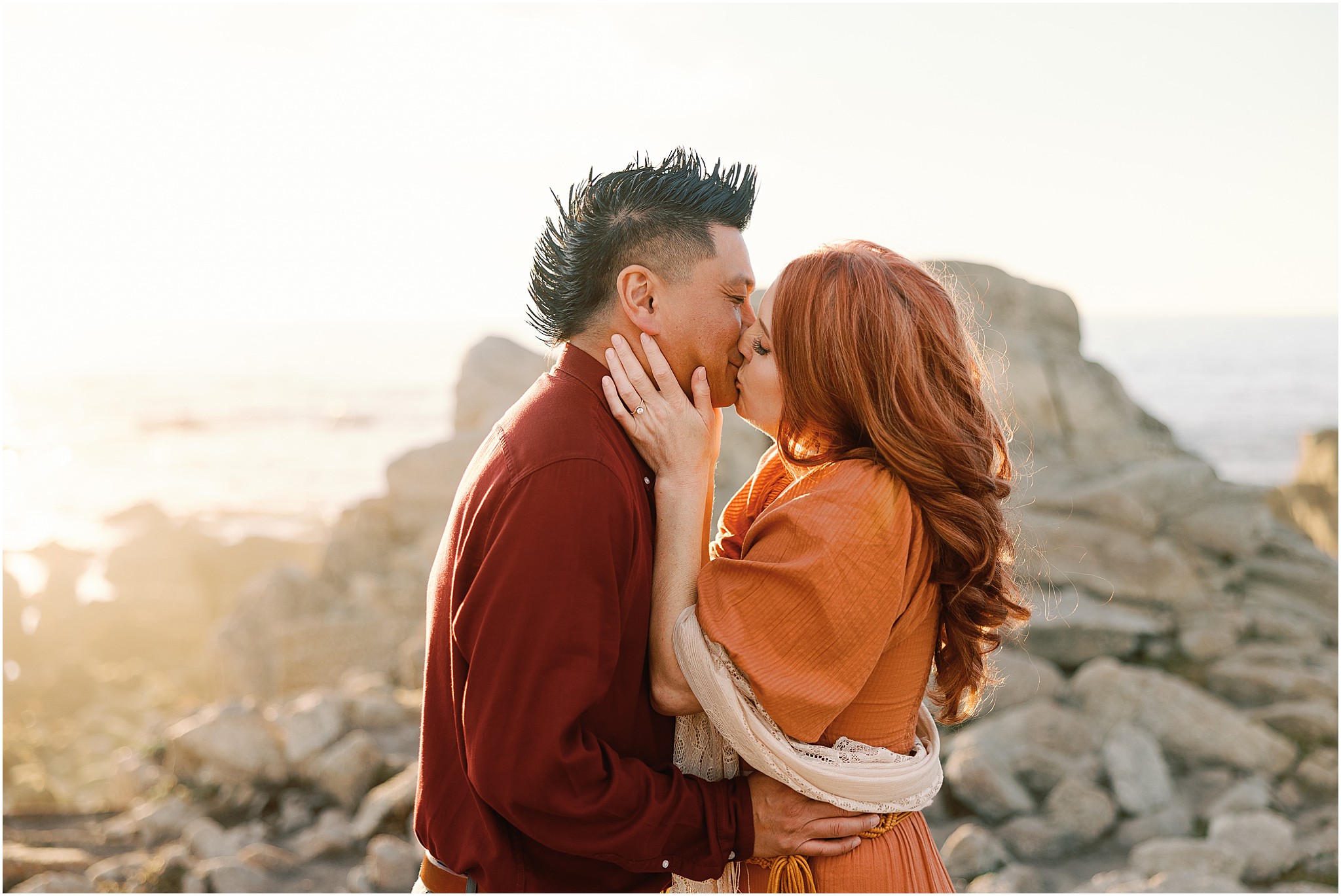 Big Sur engagement photographer documenting couple kissing by the ocean shoreline.