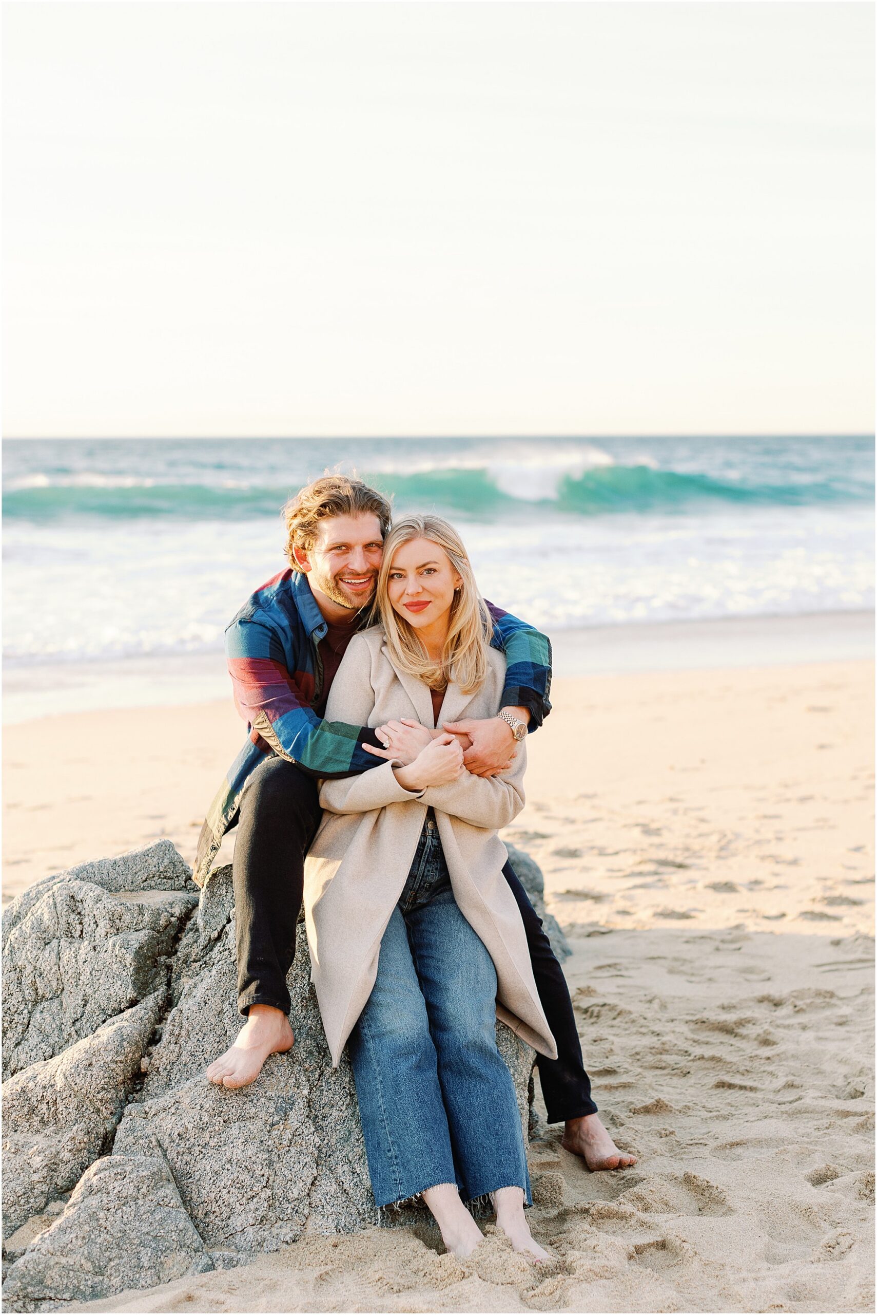 Newly engaged couple on scenic California coastline.