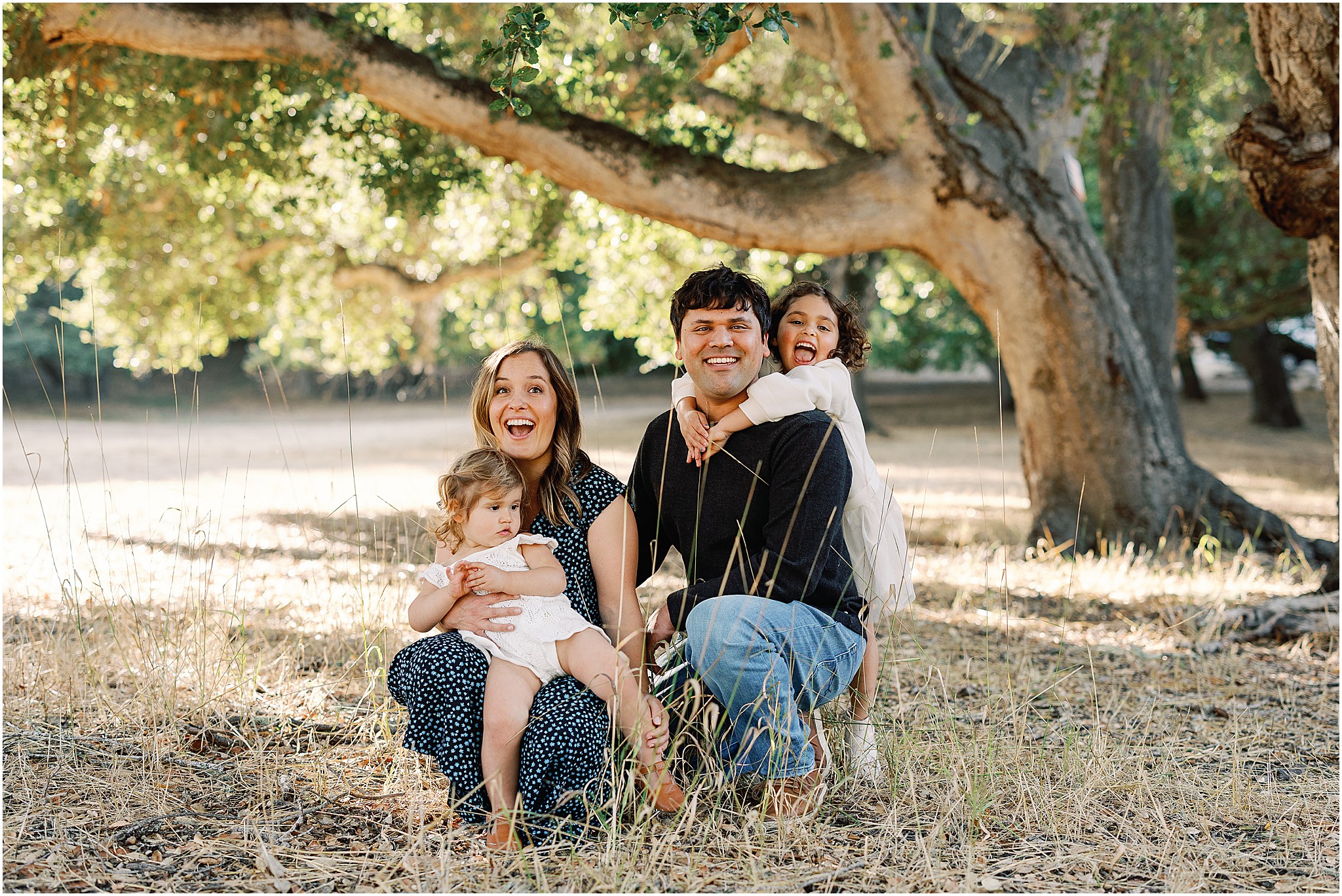 Candid family moment laughing together in Monterey County field.