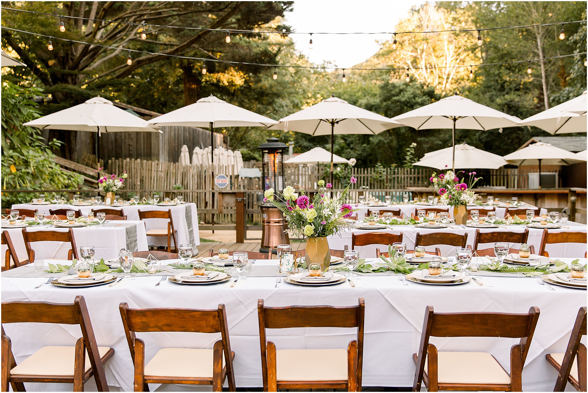 Elegant wedding reception under string lights in Big Sur forest