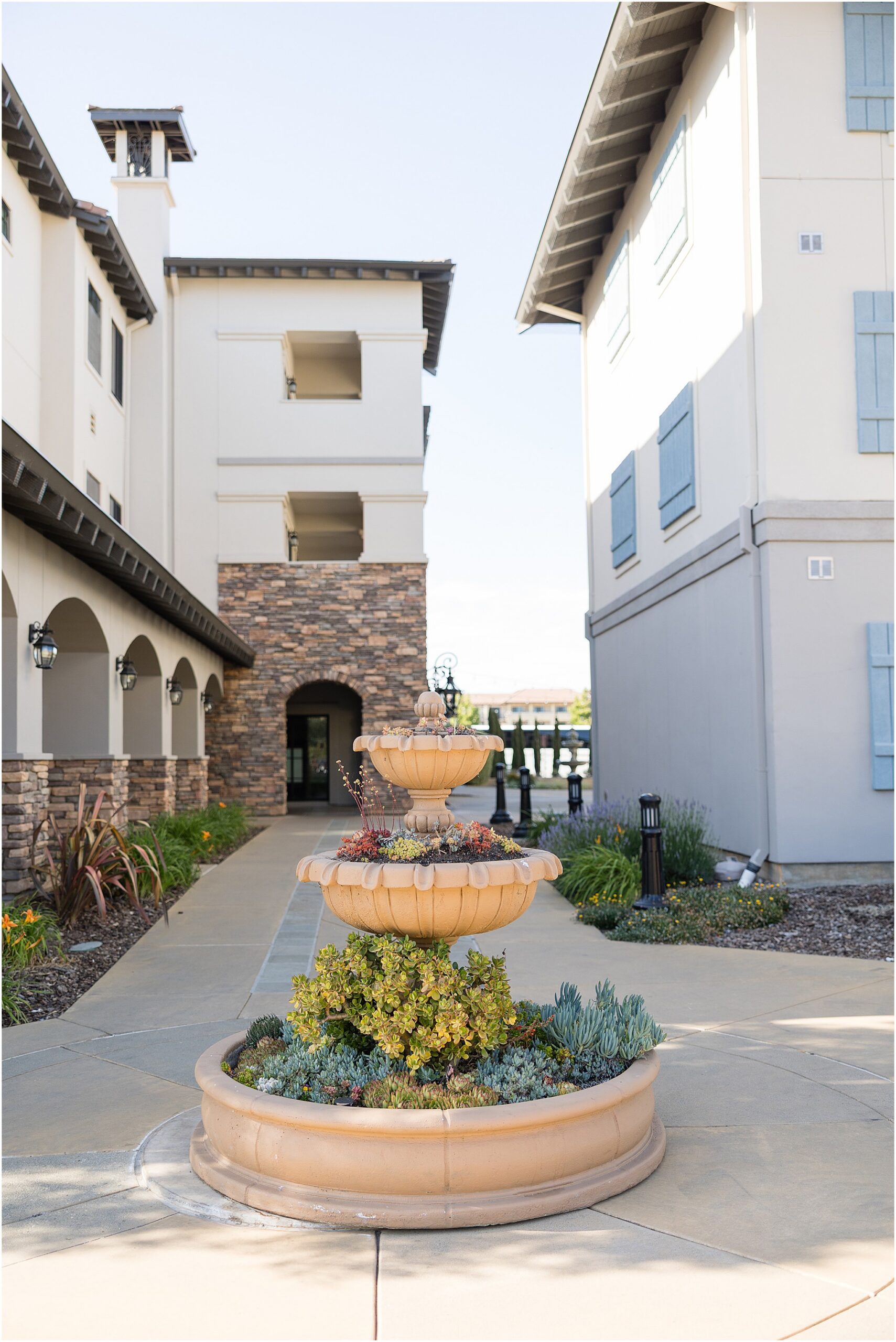 Napa Valley wedding venue building and fountain surrounded by vineyards.